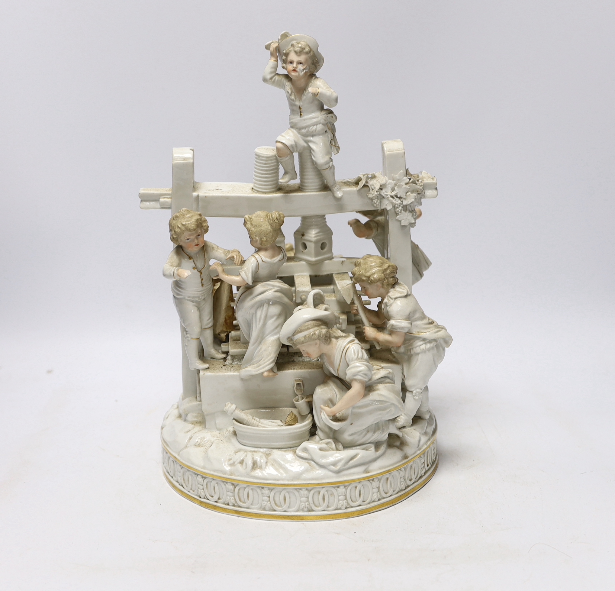 A late 19th century German white glazed porcelain group, ‘’The Wine Press’’, after a Meissen original by Johann Carl Schonheit, 33cm